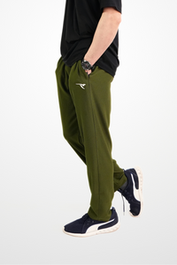 Person wearing green pants and black shirt on a white background