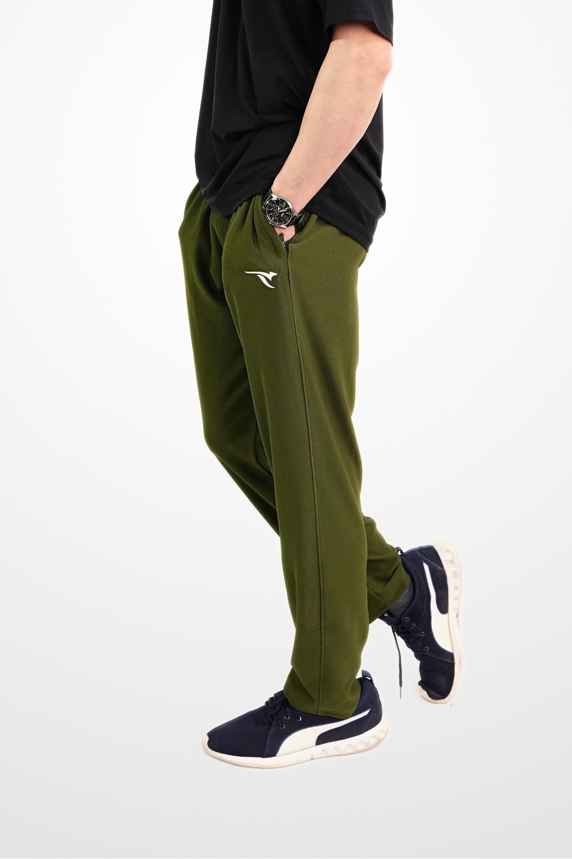 Person wearing green pants and black shirt on a white background