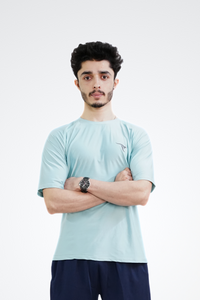 Man wearing a light blue t-shirt and navy shorts with a brand logo on a white background